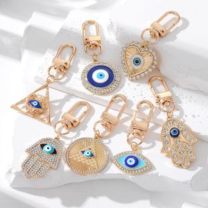 Nyckelringar Evil Eye Rhinestone Hamsa Handnyckelring för kvinnor Män Fatima Blue Bag biltillbehör Drop Leverans smycken Dhcyu