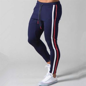 Białe jogger dresspants Men swobodne chude bawełniane spodnie siłowni trening fitness Spodnie męskie Spring Sportswear Pants P08245T