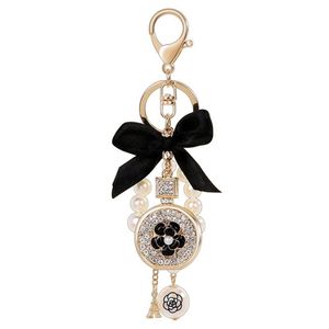 Lovely cute bow pearl flower perfume bottle keychains new fashion ins luxury designer diamond rhinestone bag charms keychains tass223A