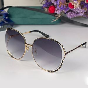 Modedesigner kvinnors solglasögon retro charmiga runda ramglasögon sommar mode mångsidig stil topp uv400 skydd och box gg0595s