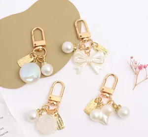 Keychains Lanyards Womens Fashion Alloy Pearl Keychain Pendant Creative Bow Peach Heart Bag Car Keychains Jewelry Accessories Gift Lady