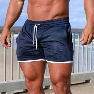 Abbigliamento da palestra Uomo Pantaloncini sportivi estivi Tinta unita Allentato Casual Street Fitness Cravatta Tasche multiple Sport all'aria aperta Corsa Ropa Hombre