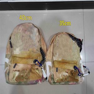 Mochila de emenda de design clássico bolsas de lazer esportivas de graffiti masculinas e femininas lona camuflada bolsa de viagem handabg grande capacidade 283U