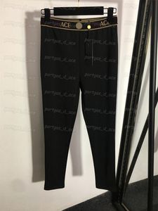 Pantaloni leggings da donna con fettuccia e lettere Pantaloni attillati in vita elastica Pantaloni neri alla moda