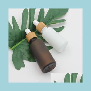 Garrafas de embalagem de vidro branco âmbar fosco garrafa conta-gotas 15 ml 30 ml 50 ml com tampa de bambu 1 oz garrafas de óleo essencial de madeira entrega drop dhvjt