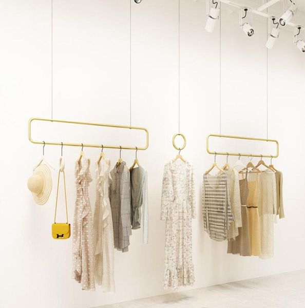 Loja de roupas expositor móveis comerciais cabide de parede shopping women039s decoração luz luxo nano roupas ouro 4691196
