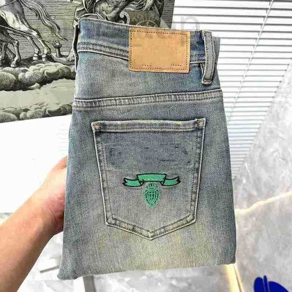 Jeans masculinos designer clássico azul triângulo carta jeans fino estiramento textura reta lavagem resistente ao desgaste top row patch motocicleta calças de negócios vintage 3hi7 9ijy