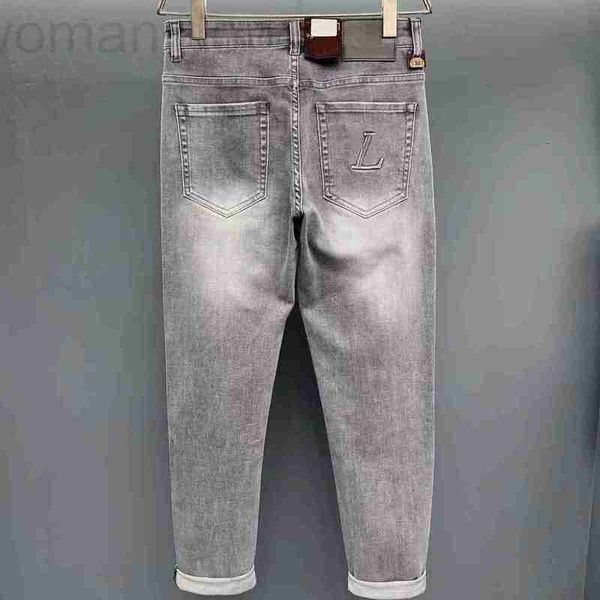 Jeans masculinos designer 2023 moda clássico jeans estilo masculino impressão quente buraco pintado magro estiramento impresso pequenos pés denim wzmf