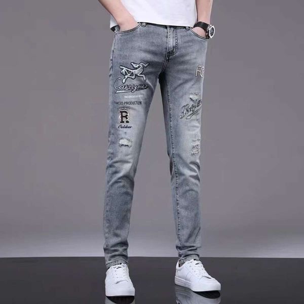 Jeans ricamati traforati di lusso leggeri di marca alla moda per la primavera e l'estate da uomo, pantaloni casual slim fit con diamanti caldi stampati di fascia alta con lettere