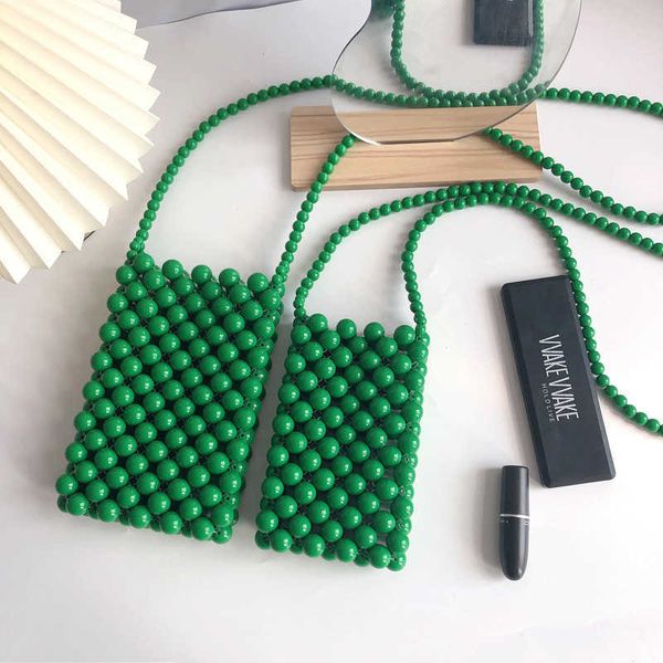 Il prodotto finito delle borse per cellulari è lo stesso della borsa per cellulare intrecciata a mano.Borsa a tracolla diagonale con perline verticali verdi perle da donna