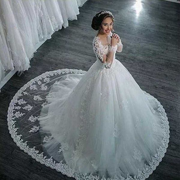 Incredibili abiti da sposa con collo trasparente Applicazioni di pizzo Perline Illusione Maniche lunghe Abiti da sposa Abiti da ballo Sweep Train Abiti da sposa personalizzati