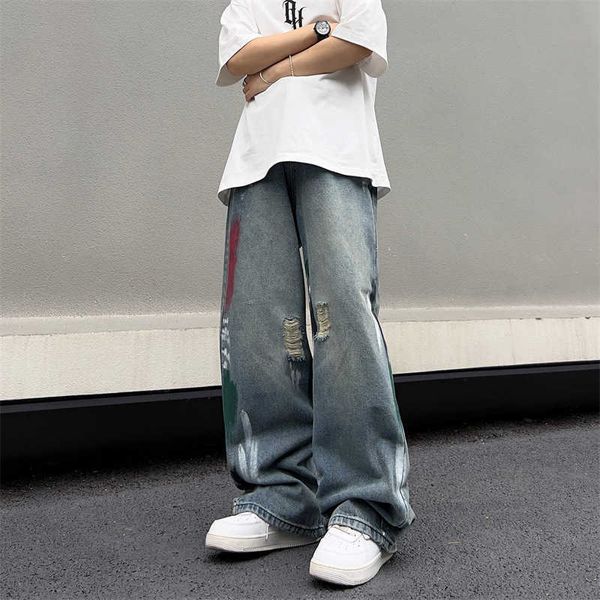 Versione coreana hip-hop di strada con buchi e design a inchiostro spruzzato esplosivo di strade dimagranti jeans boys gamba dritta gamba ampi pantaloni