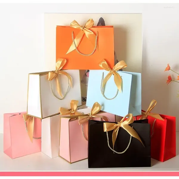 Wrap regalo 10pcs Bella borsa da kraft rosa scatola attuale per libri di abbigliamento confezione manico d'oro sacchetti di carta