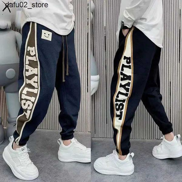 Calças masculinas calças de corrida soltas letra imprimindo roupas de rua de hip-hop da moda calça coreana de estilo coreano Nova marca de luxo masculino Q240417