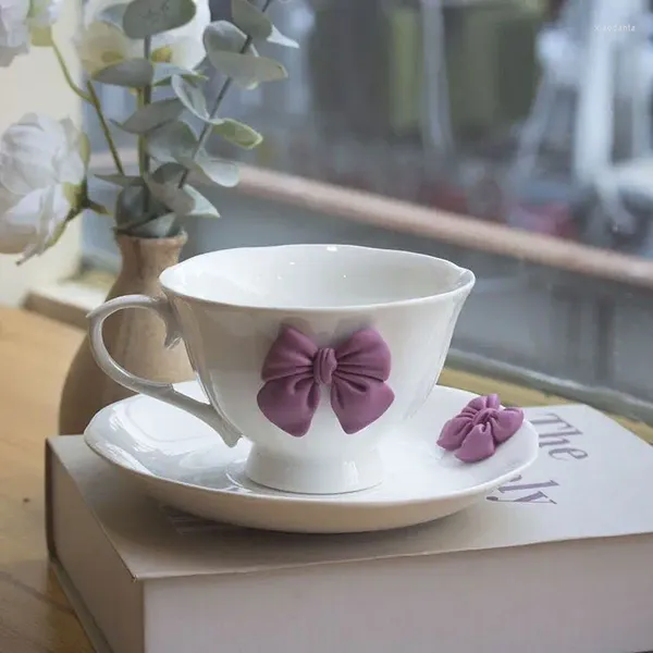 Canecas garotas lindas coração arco e vento de alto valor xícara de café e pires define um presente de chá da tarde.