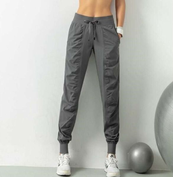 Yoga lululemenli respirável calças esportivas roupas de ginástica das mulheres corredores secagem rápida magro solto correndo treinamento fitness leggings ponto bolso casual calças 1009ess