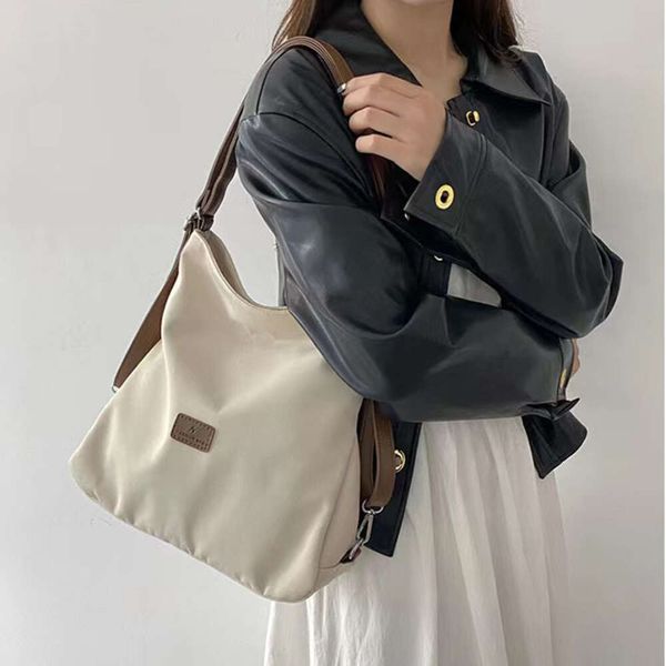 Bolsa tote de lona feminina nova alta capacidade e estilo universitário minimalista mochila moda versátil casual um ombro crossbody