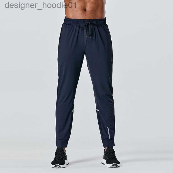 Calças masculinas 2023 designer calças compridas homens esporte correndo alinhar yoga ao ar livre ginásio bolsos fino ajuste sweatpants calça jogger calças dos homens casual cintura elástica ginásio desportivo l23