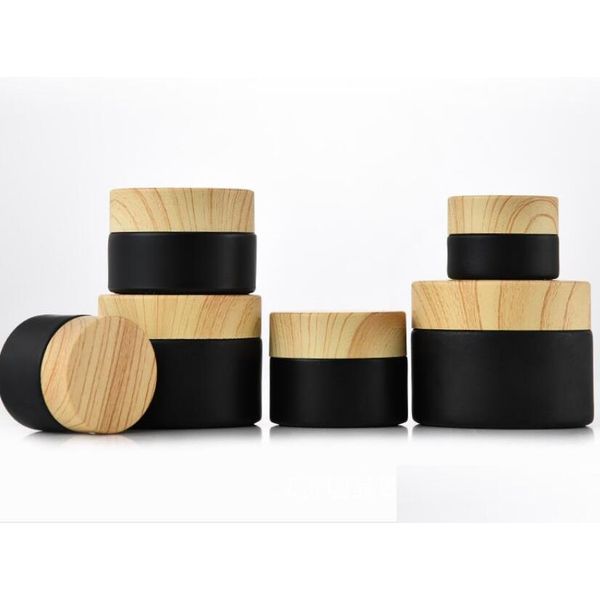 Bottiglie di imballaggio Bottiglia con coperchio in legno Barattolo di vetro nero smerigliato all'ingrosso Barattolo cosmetico con coperchi in plastica con venature del legno Fodera in Pp 5G 10G 15G 20G Dhdg4