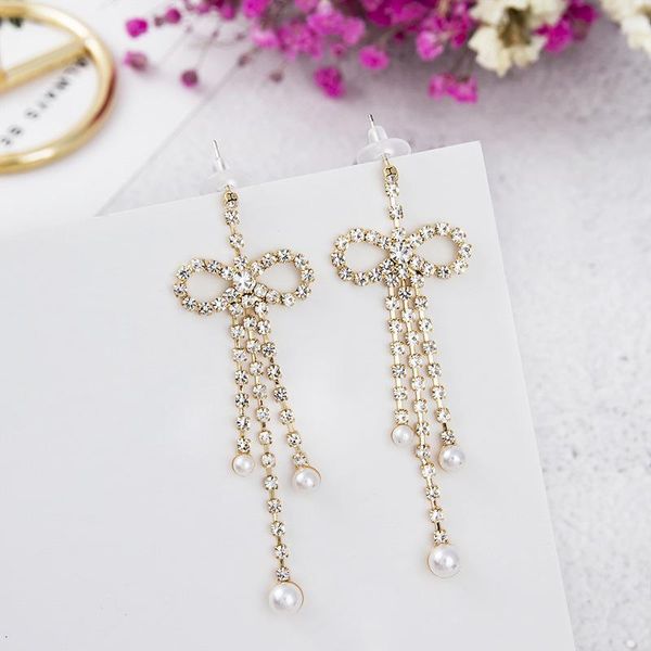 Brincos de balanço dominaram 2023 Crystal Fine Crystal Bowknot Drop Temperamento Doce Pearl Tassel Tassel Hyperbole Style Jóias Lustre