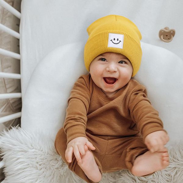 M609 Novo Inverno Inverno Inverno Infantil Baby Kids Hat Smile Padrão Crianças Giradas Caps Captos de Lã Aqueadores