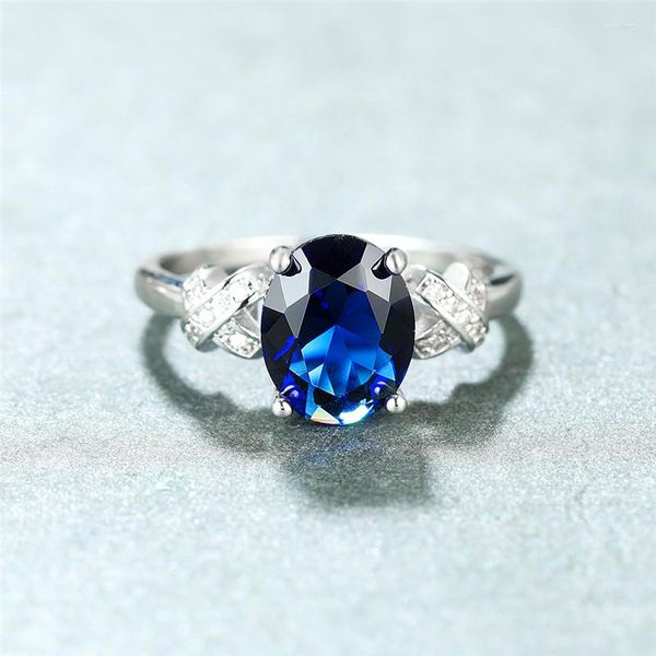 Eheringe Luxus weiblicher blauer Kristall Stein Ring Klassische Silberfarbe Kreuz für Frauen zierliche Braut Oval Engagement