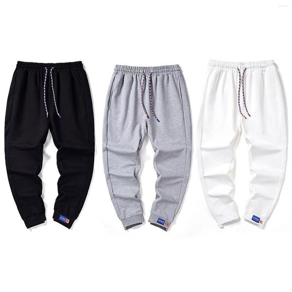 As calças masculinas nas calças de primavera e outono estão na moda amarrada com nove pés. Sports Casual Pants. Menino Estrela de espuma de meia