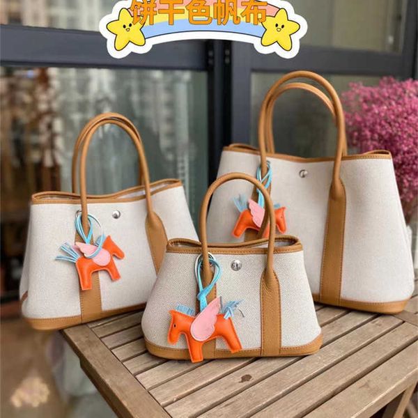 Designer Hremmss Party Garden Tote Sags for Women Online Store Celebridade Mesmo Bolsa de Estilo 2023 Novo ombro único Crossbody Tela com couro tem logotipo real