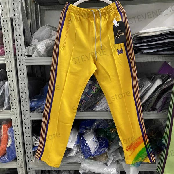 Pantaloni da uomo Pantaloni da pista con aghi gialli Pantaloni da tuta da donna di alta qualità in poliestere liscio Pantaloni a righe viola lavorati a farfalla T231214