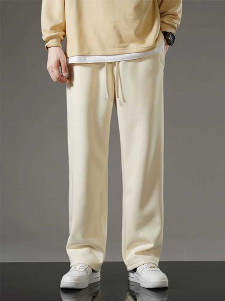 Pantaloni da uomo 2023 Nuovi vetri autunnali per i pantaloni della tuta coreana Fashion Sports Affari sportivi Pantaloni per pista dritti di cotone Pantaloni sciolti di cotone J231222 J231222