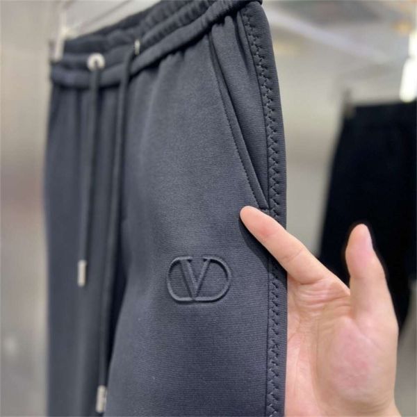 Tendência europeia minimalista preto calças casuais para outono e inverno masculino 2023 novo padrão bordado magro ajuste leggings