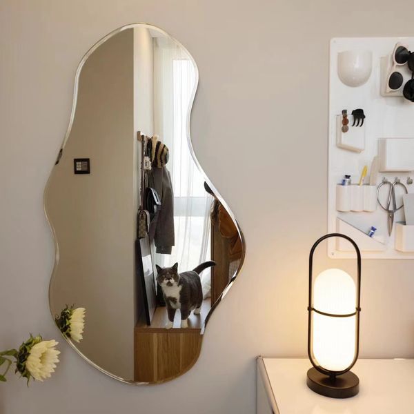 Gli specchietti irregolari nei negozi di abbigliamento mostrano dimagrimento ed elevata bellezza e specchi a forma di casa