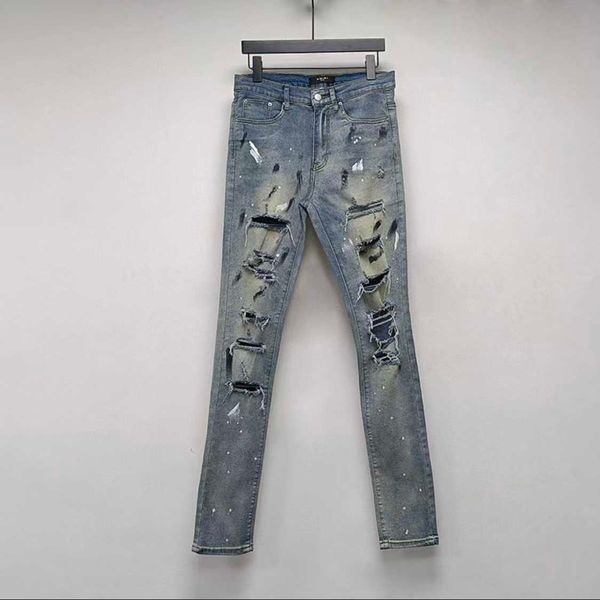 Designer-Kleidungs-Denim-Hose Amiiri Speckled Ink Hole Blue Jeans Handgemachter Messerschnitt Beschädigte High Street Elastische Wasserwäsche Gebrauchte Slim Fit Distressed Zerrissene Hose