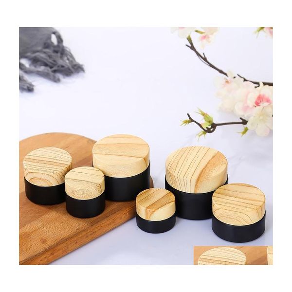 Bottiglie di imballaggio barattolo in vetro glassato nero con bottiglia cosmetica in legno in legno per le lozioni cosmetiche body scrub ot7vo