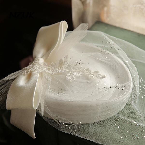 Cabeças de cabeceiras no casamento fascinador branco chique chique banquete