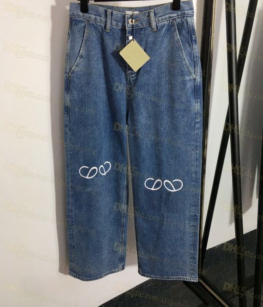 Женские джинсы с высокой талией на улице вышиты на вышивших логотипах.