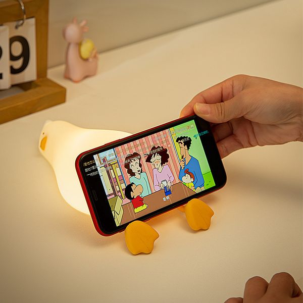 Simpatica anatra con luce notturna a LED supporto per cellulare morbido regalo creativo in silicone