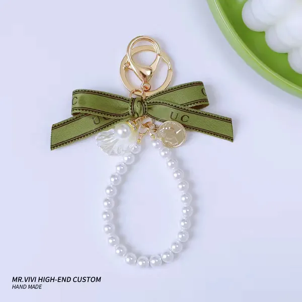 Portachiavi per auto di moda Ciondolo Casual Campana antica Orchidea Nastro verde Perla Portachiavi Designer con catena pendente con fiocco a cuore con lettera