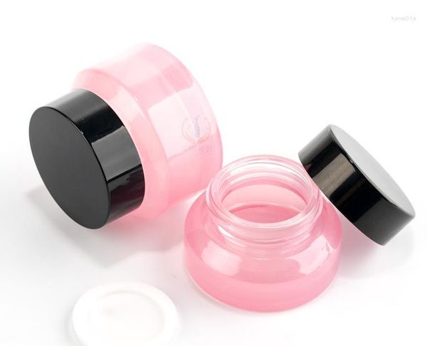 Bottiglie di stoccaggio 100 pezzi 15G 30G 50G Vaso di vetro per trucco rosa con coperchio nero Sigillo Contenitore da 1 oz Confezione cosmetica Vaso per la cura della pelle SN868