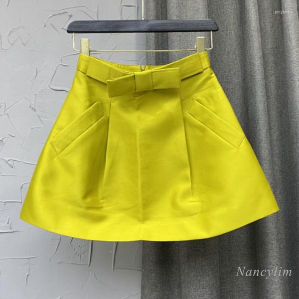 Saias de saia amarela para mulheres 2022 Primavera e verão Tridimensional cintura arco A-line Satin mini Faldas roupas femininas