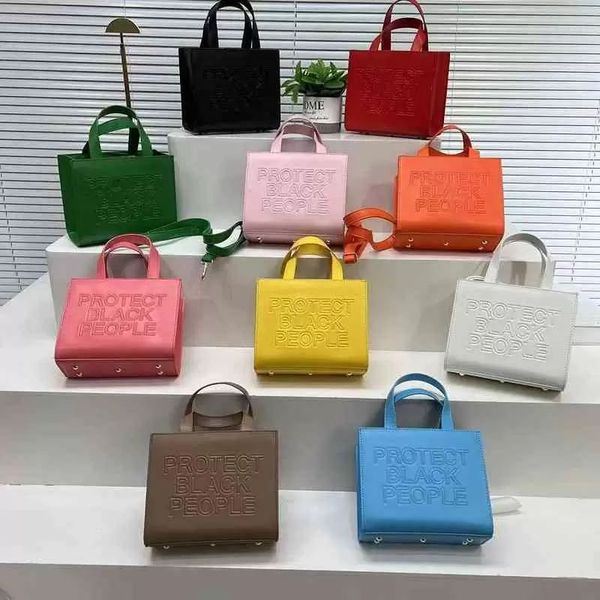 Designer Tote Crossbody bolsa de couro para compras de personagem Carta de carta Mulheres protegem Pessoas negras Bolsa de ombro