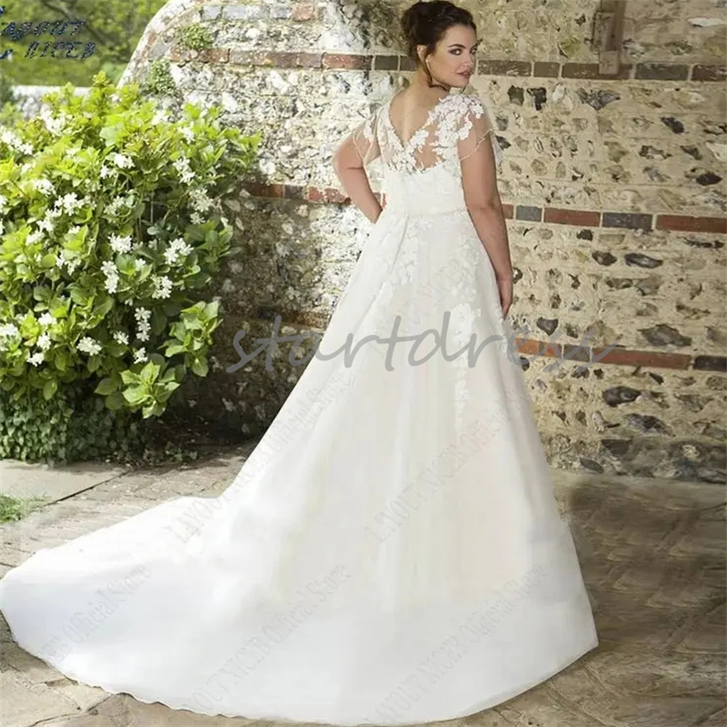 Abito da sposa maniche a mantella taglie forti Collo trasparente Abito da sposa country con applicazioni Appliques Abiti da sposa senza schienale in pizzo Abiti eleganti da sposa Vestios De Novias