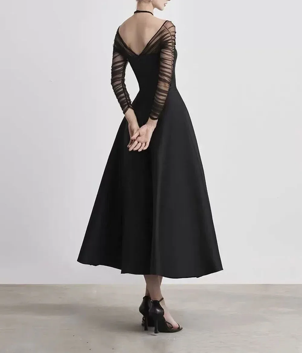 Robe de soirée mi-longue noire pour femmes, nouveau produit automne/hiver 2024, haute qualité, manches transparentes, panneau