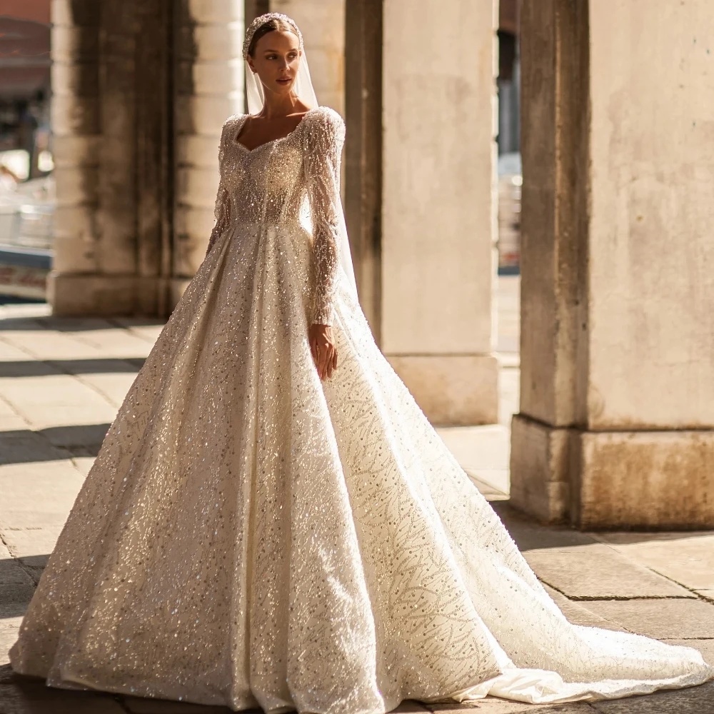 Robes de mariée élégantes une ligne de robes nuptiales paillettes perles de moustilles à manches longues transparentes