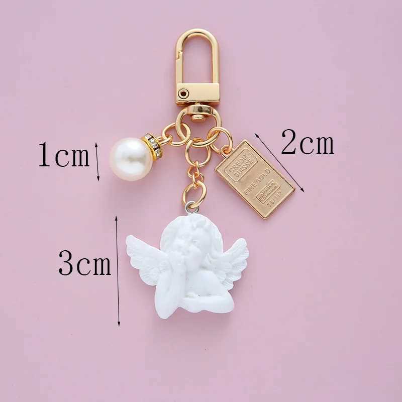 Tornari percorsi Creative retro White Angel keychain Womens Cute Mini Pearl a forma di cuore Auto Tortale Torching Bignetto Gioielli affascinanti J240509