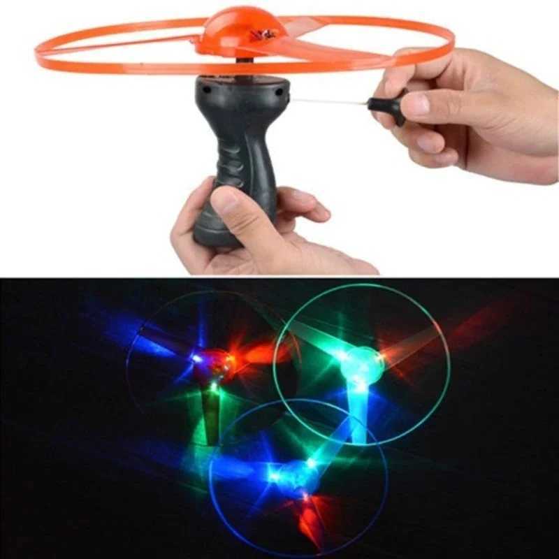 LED Flying Toys Funny Spinning Flyer Luminous Flying UFO LED Light Handle Flash Toys for Kids Outdoor Game Color Random 240410