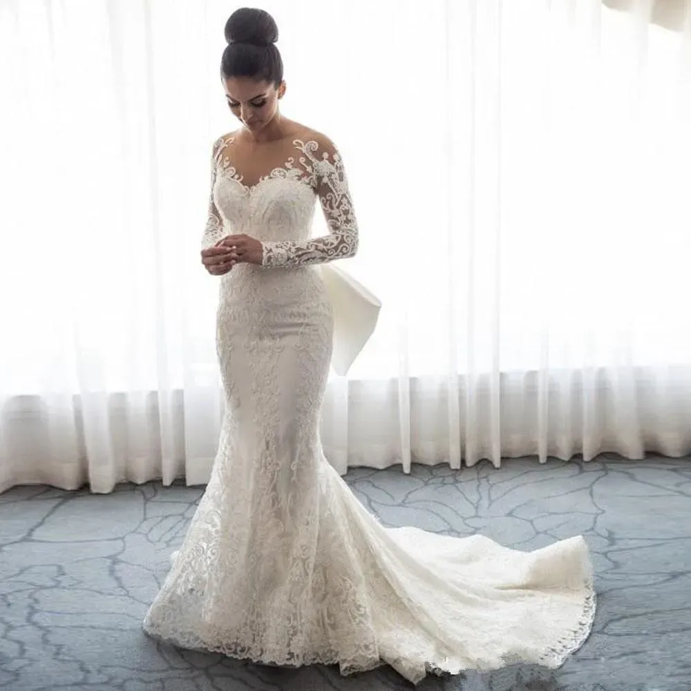 2021 Luxury Mermaid Wedding Dresses Sheer Neck Long Sleeves Illusion Full Lace Applique Bow Overskirts Button Back Chapel Train Bridal Gowns