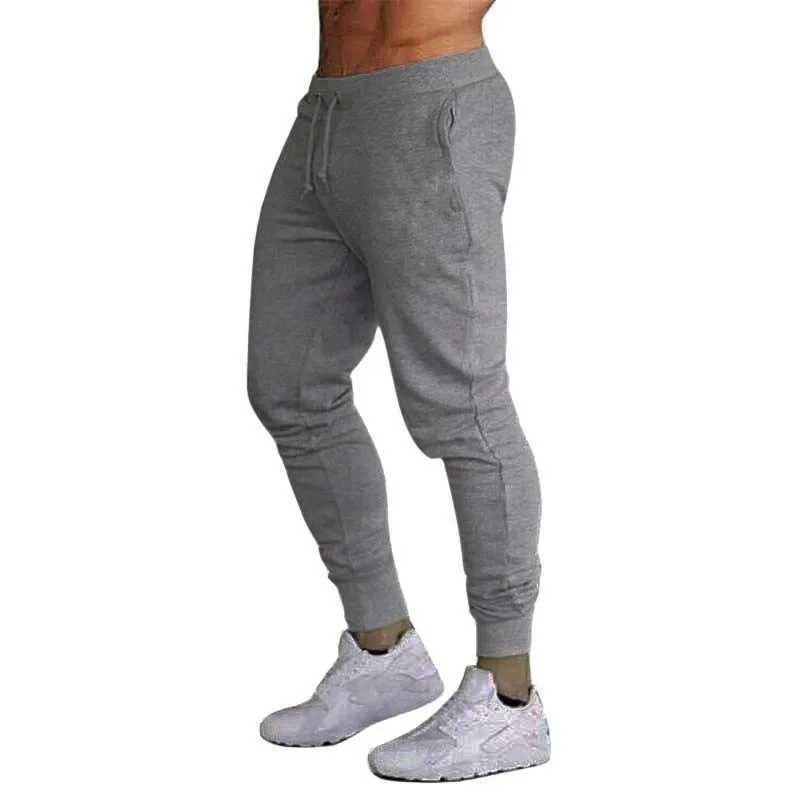 Calças masculinas Primavera de calças novas esportivas de calças esportivas de cor sólida de cor sólida Livros casuais de fechamento S-3xl D240425