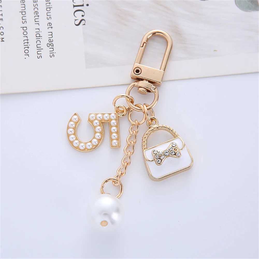 Keychains Lanyards Luxury Handbag Pendant Keychains Fashion Pearl Number 5 Tassel Keyring For Women Bag Ornament Car Key Chains smycken Tillbehör