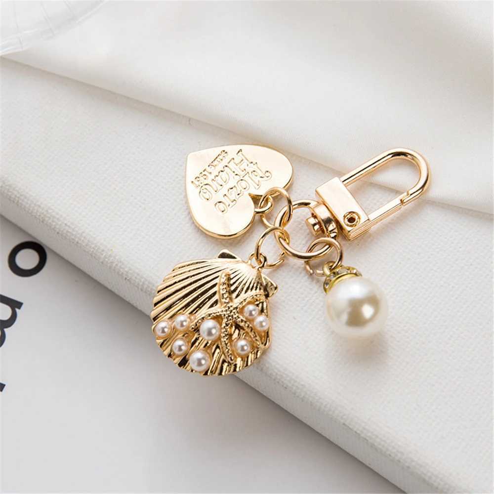 Keychains Lanyards Luxury Artificial Pearl Keychain Metal Peach Heart Pendant Keyring Women Fashion Headphone Case Charm Bag smycken Tillbehör